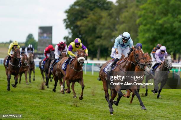 Tom Marquand riding Starman celebrates as he crosses the line to win The Darley July Cup Stakes at Newmarket Racecourse on July 10, 2021 in...