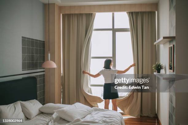 rear view asian chinese teenage girl open curtain of her bedroom in the morning - malaysia beautiful girl 個照片及圖片檔