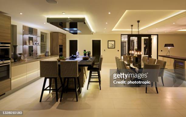 elegant kitchen diner during the evening - downlight stock pictures, royalty-free photos & images