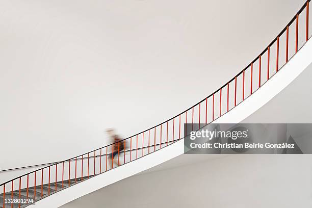 girl goes down staircase - christian college fotografías e imágenes de stock