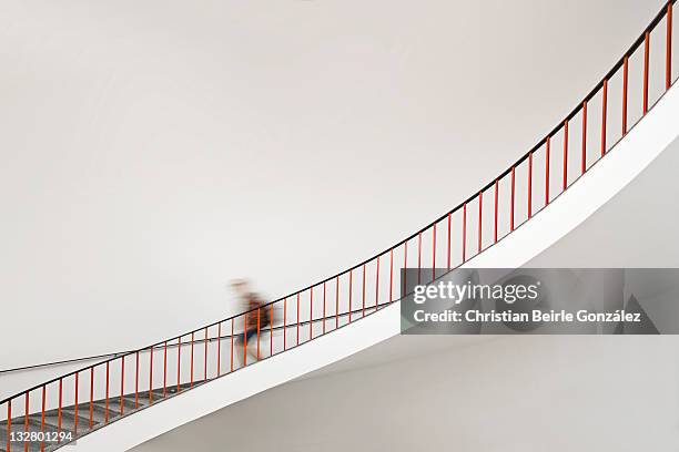 girl goes down staircase - staircase imagens e fotografias de stock
