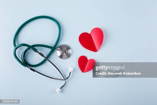 nurses day concept. medical stethoscope, two red hearts. healthcare medicine concept. flat lay. - stethoscope heart stock-fotos und bilder