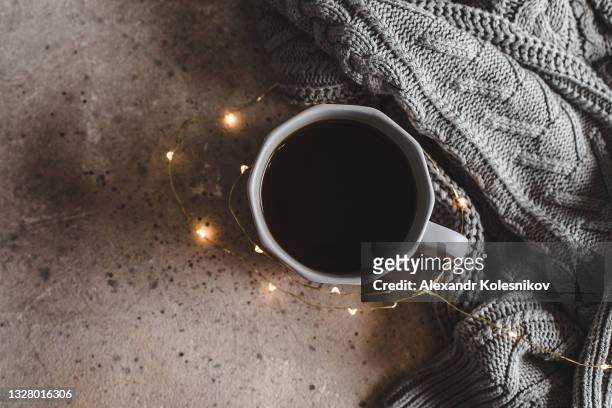 christmas cozy mood concept. top view of mug black coffee and gray sweaters. - coffee christmas ストックフォトと画像