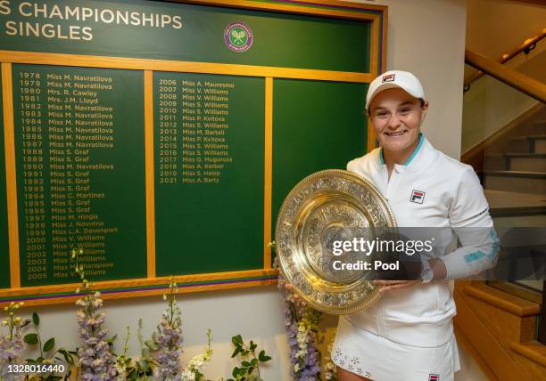 Ashleigh Barty of Australia poses with the Venus Rosewater Dish trophy and the Ladies’ Singles Board after winning her Ladies' Singles Final match...