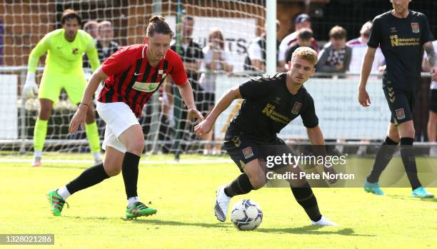 Sam Hoskins of Northampton Town controls the ball watched by Liam Roche of Sileby Rangers during the Pre-Season Friendly match between Sileby Rangers...