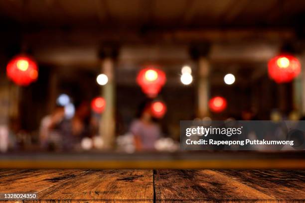 wood table with blur of people in cafe or restaurant on background. - restaurant background stock pictures, royalty-free photos & images