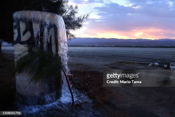 Water is pumped into an irrigation canal shortly after sunrise amid drought conditions on July 10, 2021 near Indio, California. According to the...