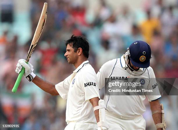 Indian batsman Rahul Dravid raises his bat to acknowledge the crowd after completing his century during the first day of second Test match between...