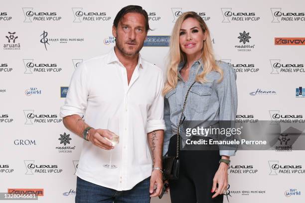 Former Italian football player Francesco Totti and his wife Italian showgirl Ilary Blasi pose for a picture at the backdrop before the dinner gala of...