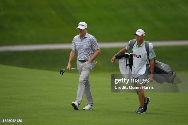 Steve Flesch and caddie walk to the ninth hole during the third round of the U.S. Senior Open Championship at the Omaha Country Club on July 10, 2021...