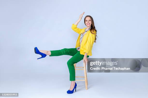 happy woman sitting on a chair - woman excited sitting chair stock pictures, royalty-free photos & images