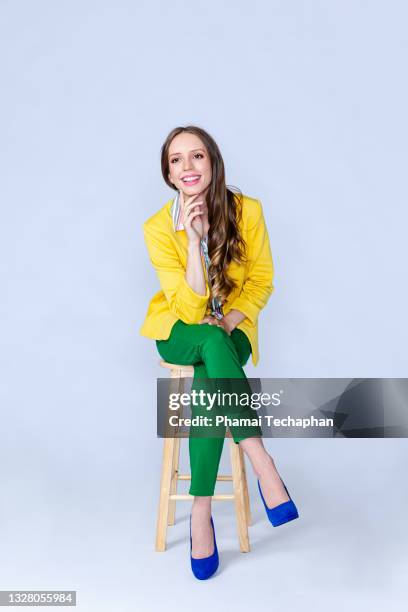 happy woman sitting on a chair - business woman full body isolated stock pictures, royalty-free photos & images