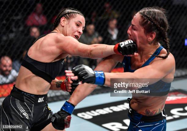 Jennifer Maia of Brazil punches Jessica Eye in their flyweight fight during the UFC 264 event at T-Mobile Arena on July 10, 2021 in Las Vegas, Nevada.