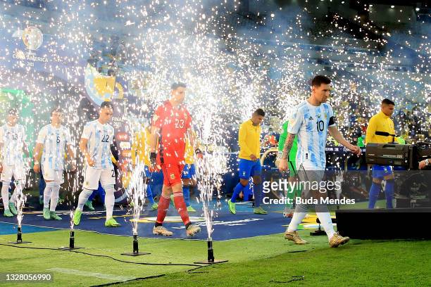 Lionel Messi of Argentina leads his team as they enter the pitch prior to the final of Copa America Brazil 2021 between Brazil and Argentina at...