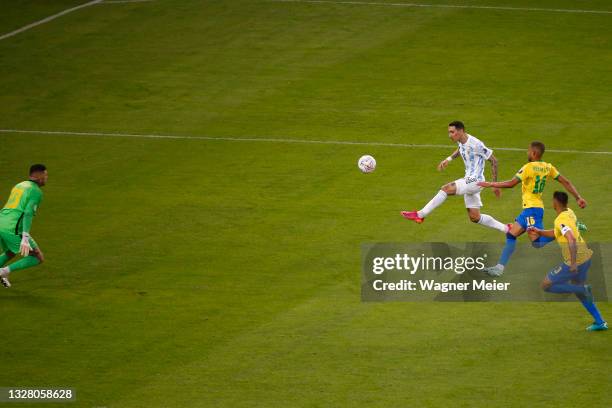 Angel Di Maria of Argentina shoots on target to score the the first goal of his team against Ederson of Brazil during the final of Copa America...