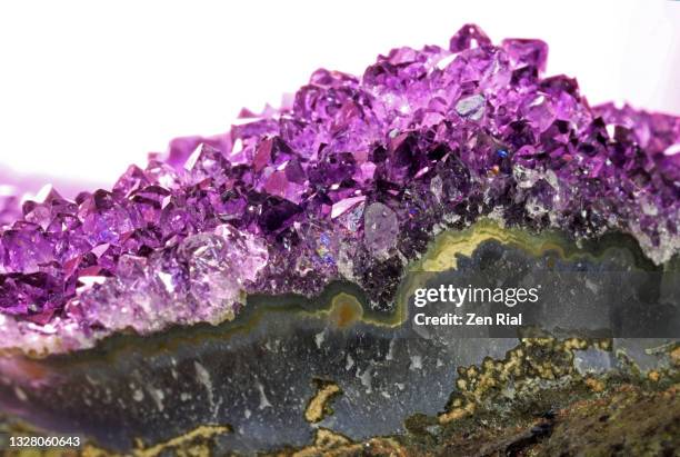 piece of a geode with amethyst crystals inside - crystals stock pictures, royalty-free photos & images