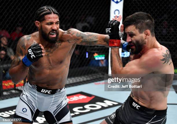 Max Griffin punches Carlos Condit in their welterweight fight during the UFC 264 event at T-Mobile Arena on July 10, 2021 in Las Vegas, Nevada.