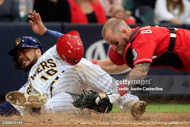 Omar Narvaez of the Milwaukee Brewers is tagged out by Tucker Barnhart of the Cincinnati Reds at home during the sixth inning at American Family...
