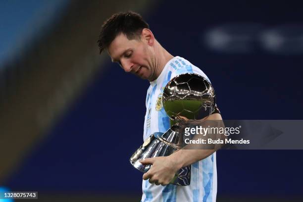 Lionel Messi of Argentina holds his top scorer award after winning the final of Copa America Brazil 2021 between Brazil and Argentina at Maracana...