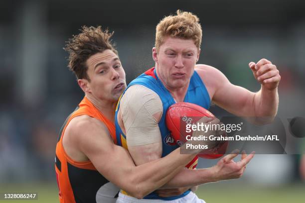 Matthew Rowell of the Suns is tackled during the round 17 AFL match between Greater Western Sydney Giants and Gold Coast Suns at Mars Stadium on July...