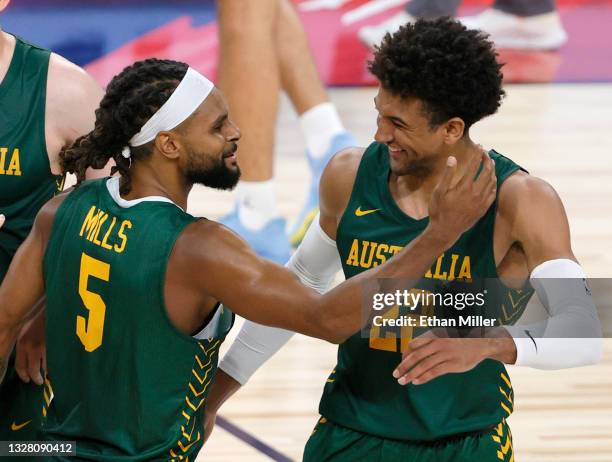 Patty Mills of the Australia Boomers celebrates with teammate Matisse Thybulle after Mills hit a 3-pointer against Argentina at the end of regulation...