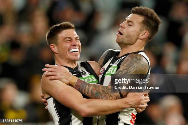 Josh Thomas and Jamie Elliott of the Magpies celebrates a goal during the round 17 AFL match between Richmond Tigers and Collingwood Magpies at...