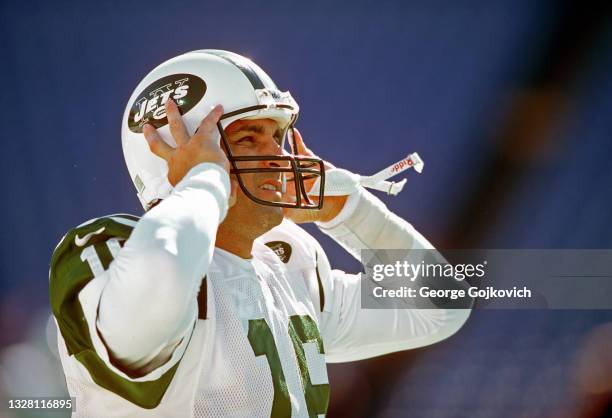 Quarterback Vinny Testaverde of the New York Jets adjusts his helmet as he looks on from the field before a game against the Buffalo Bills at Ralph...