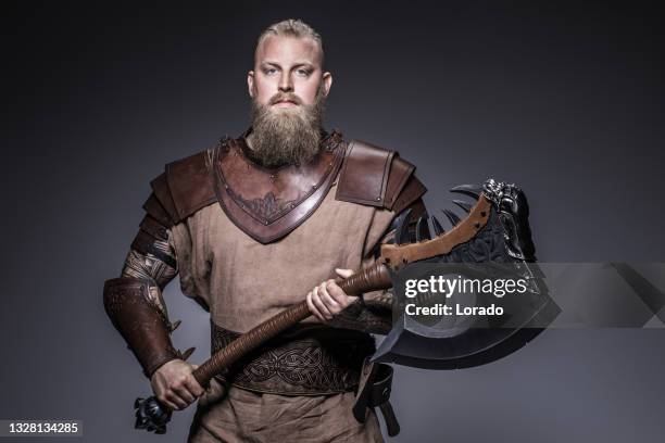 weapon wielding viking warrior in studio shot - viking warrior stock pictures, royalty-free photos & images