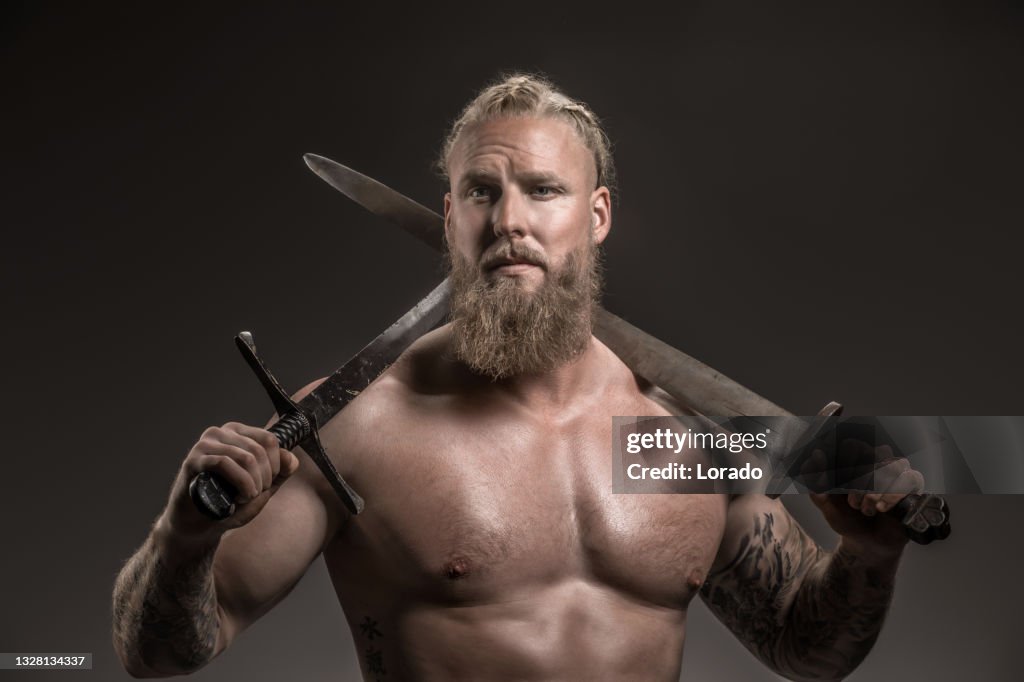Weapon wielding viking warrior in studio shot