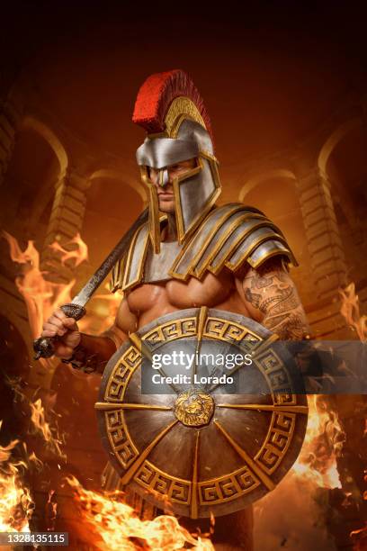 a redhead warrior gladiator in a fire filled fighting arena - gladiator armour stock pictures, royalty-free photos & images