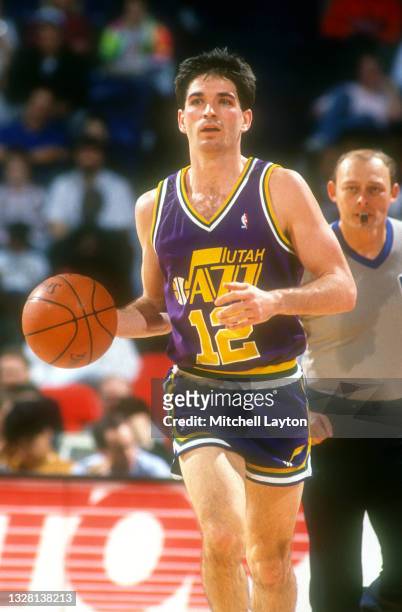 John Stockton of the Utah Jazz dribbles up court during a NBA basketball game against the Washington Bullets on December 2, 1989 at the Capital...