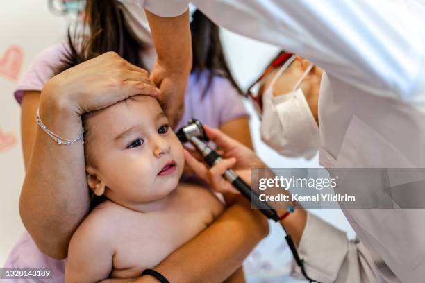 close up of a pediatrician having a check up on her baby patient - kid listening stock pictures, royalty-free photos & images