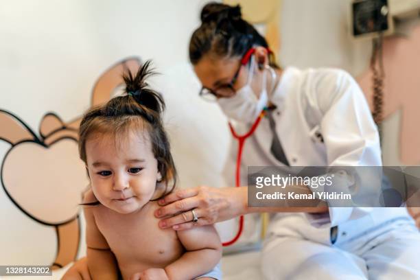 close up of a pediatrician having a check up on her baby patient - stethoscope child stock pictures, royalty-free photos & images