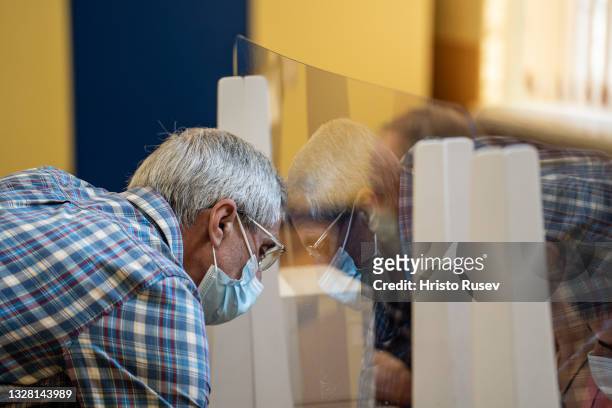 An elderly man casts his vote, during the Parliamentary Elections at a polling station on July 11, 2021 in Sofia, Bulgaria. Bulgarians will vote for...