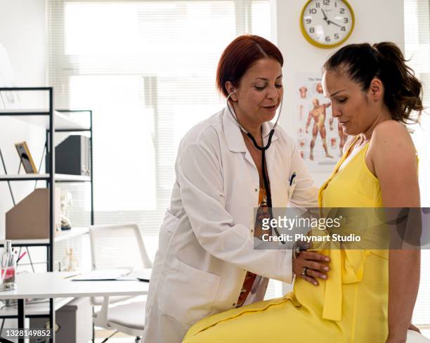 happy pregnant woman visit gynecologist doctor at hospital or medical clinic for pregnancy consultant. - prenatal care stock pictures, royalty-free photos & images