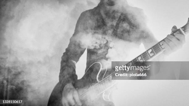 rock guitarist playing guitar in a live show with stage lights - guitar imagens e fotografias de stock