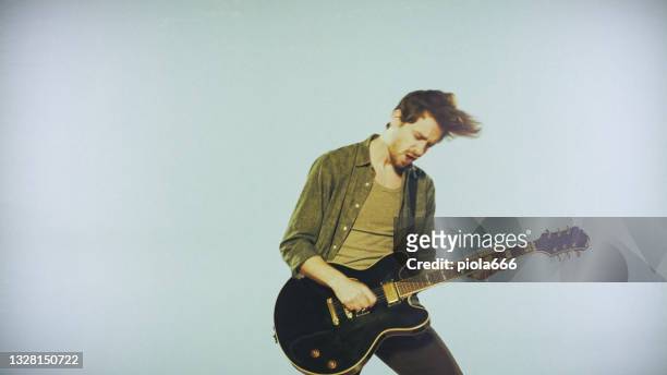 rock guitarist playing guitar in a live show white background - rock star stock pictures, royalty-free photos & images