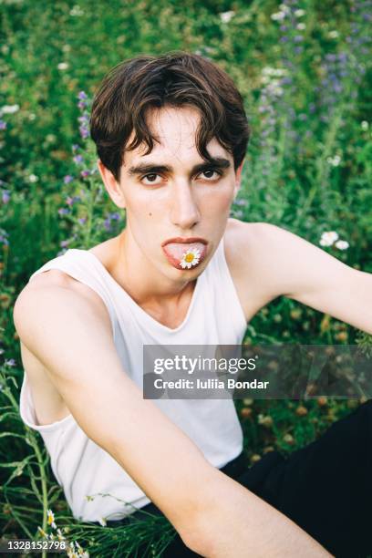 young man in flowers - editorial fotografías e imágenes de stock