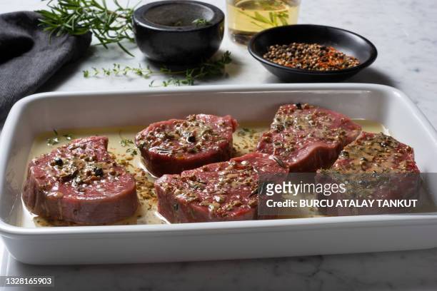 marinating meat with herbs and seasonings - marinated stock pictures, royalty-free photos & images