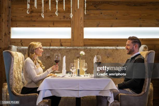 beautiful couple dining in luxury hotel restaurant - couple fine dining imagens e fotografias de stock