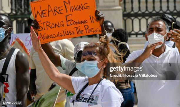 Mask-clad Brazilian immigrant takes part of the demonstration in Praça do Comercio to protest against current practices by SEF related to immigrants...