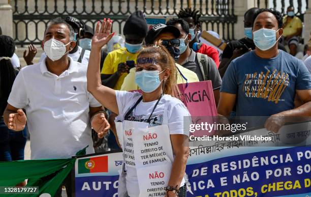 Mask-clad Brazilian immigrant takes part of the demonstration in Praça do Comercio to protest against current practices by SEF related to immigrants...