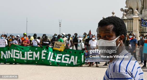 Mask-clad Angolan immigrant takes part of the demonstration in Praça do Comercio to protest against current practices by SEF related to immigrants...