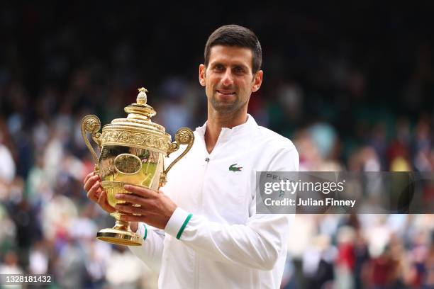 Novak Djokovic of Serbia celebrates with the trophy after winning his men's Singles Final match against Matteo Berrettini of Italy on Day Thirteen of...