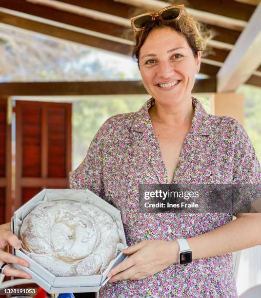 woman holding a typical sweet from mallorca - heritage round one imagens e fotografias de stock