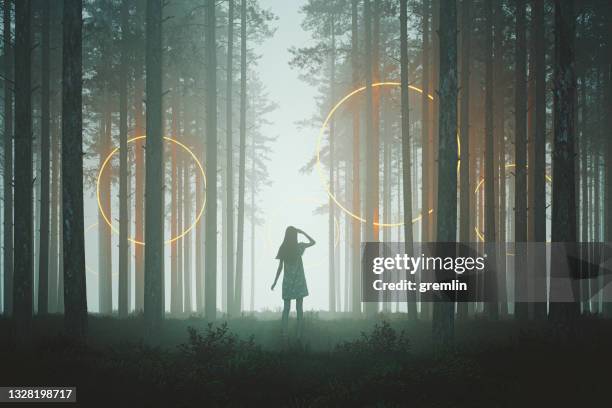 woman looking at mysterious rings in the forest at night - alien arrival stock pictures, royalty-free photos & images