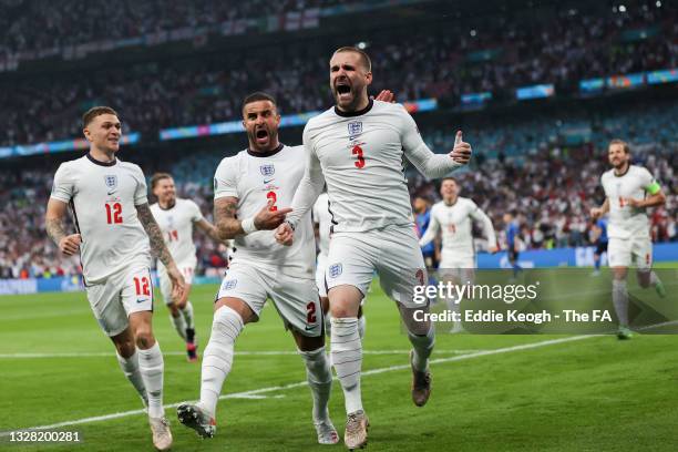 Luke Shaw of England celebrates with teammate Kyle Walker after scoring their team's first goal during the UEFA Euro 2020 Championship Final between...
