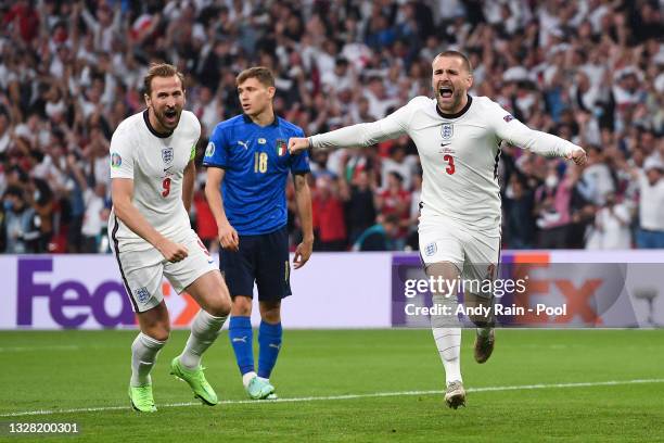 Luke Shaw of England celebrates with teammate Harry Kane after scoring their team's first goal during the UEFA Euro 2020 Championship Final between...