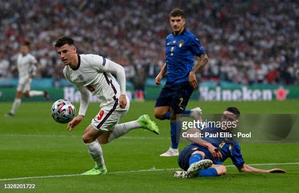 Mason Mount of England evades the tackle of Jorginho of Italy during the UEFA Euro 2020 Championship Final between Italy and England at Wembley...