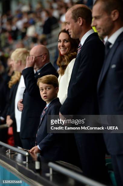 Prince George of Cambridge, Catherine, Duchess of Cambridge, and Prince William, Duke of Cambridge and President of the Football Association are seen...